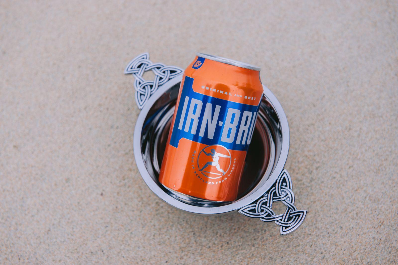 A can of Irn-Bru in a silver Celtic quaich on the sand at a Scottish beach wedding