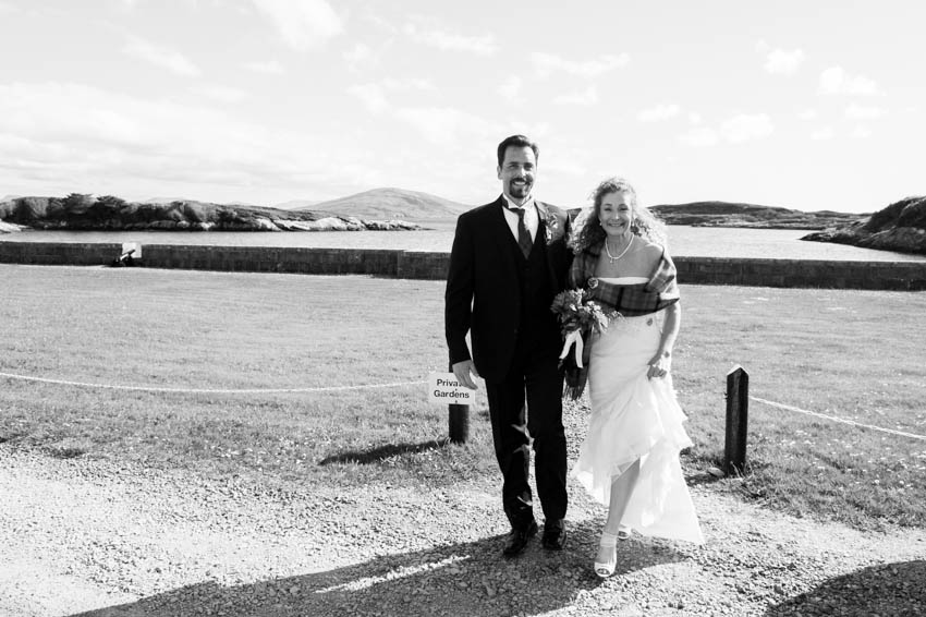 Newlyweds Nicolene and Craig walk through the grounds of  Amhuinnsuidhe Castle after their elopement. 