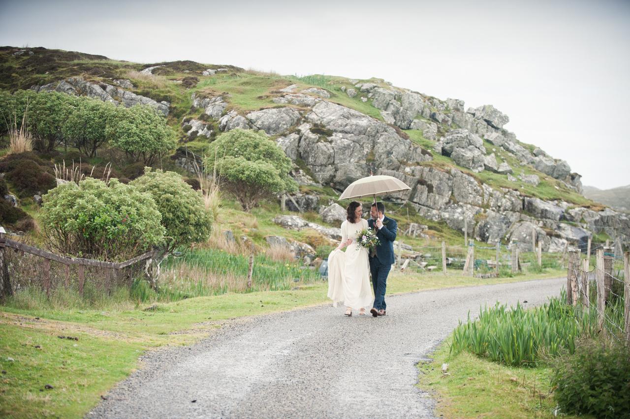 Newlyweds Emma and Jamie walk along a path on the Isle of Harris, where they married in the rain with just two witnesses. 