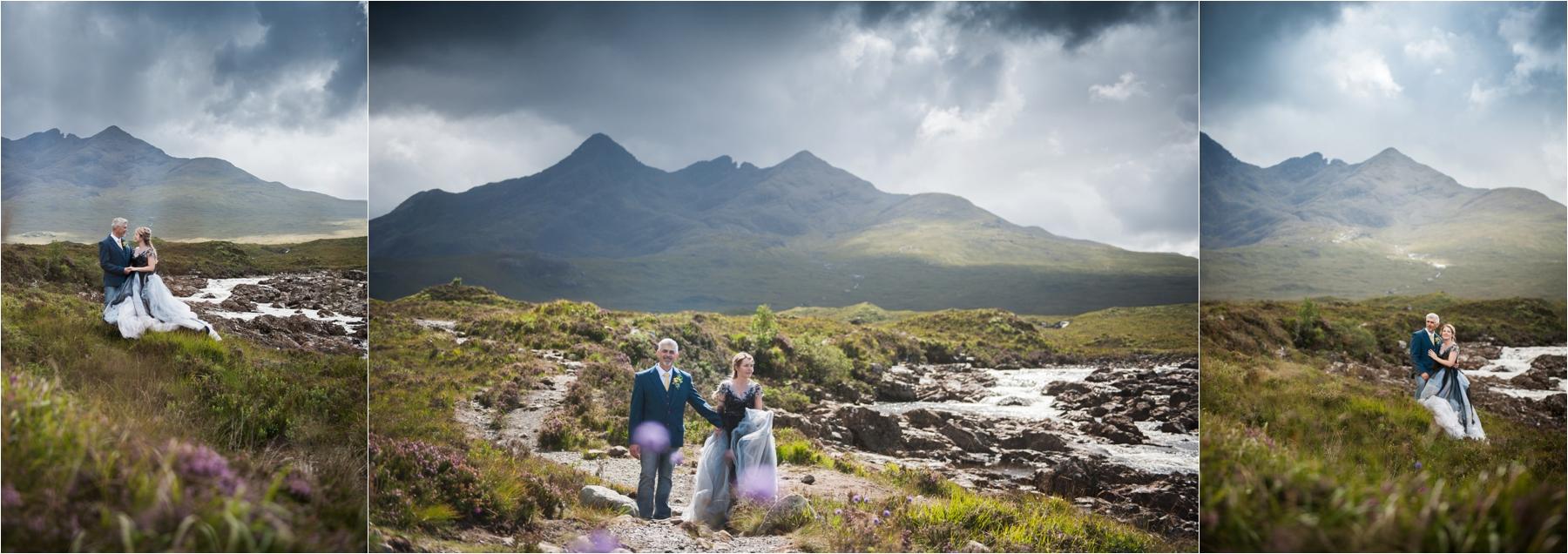 Bride and groom photos with stormy skies on the Isle of Skye. The bride is wearing a blue and grey bridal gown over walking boots. 
