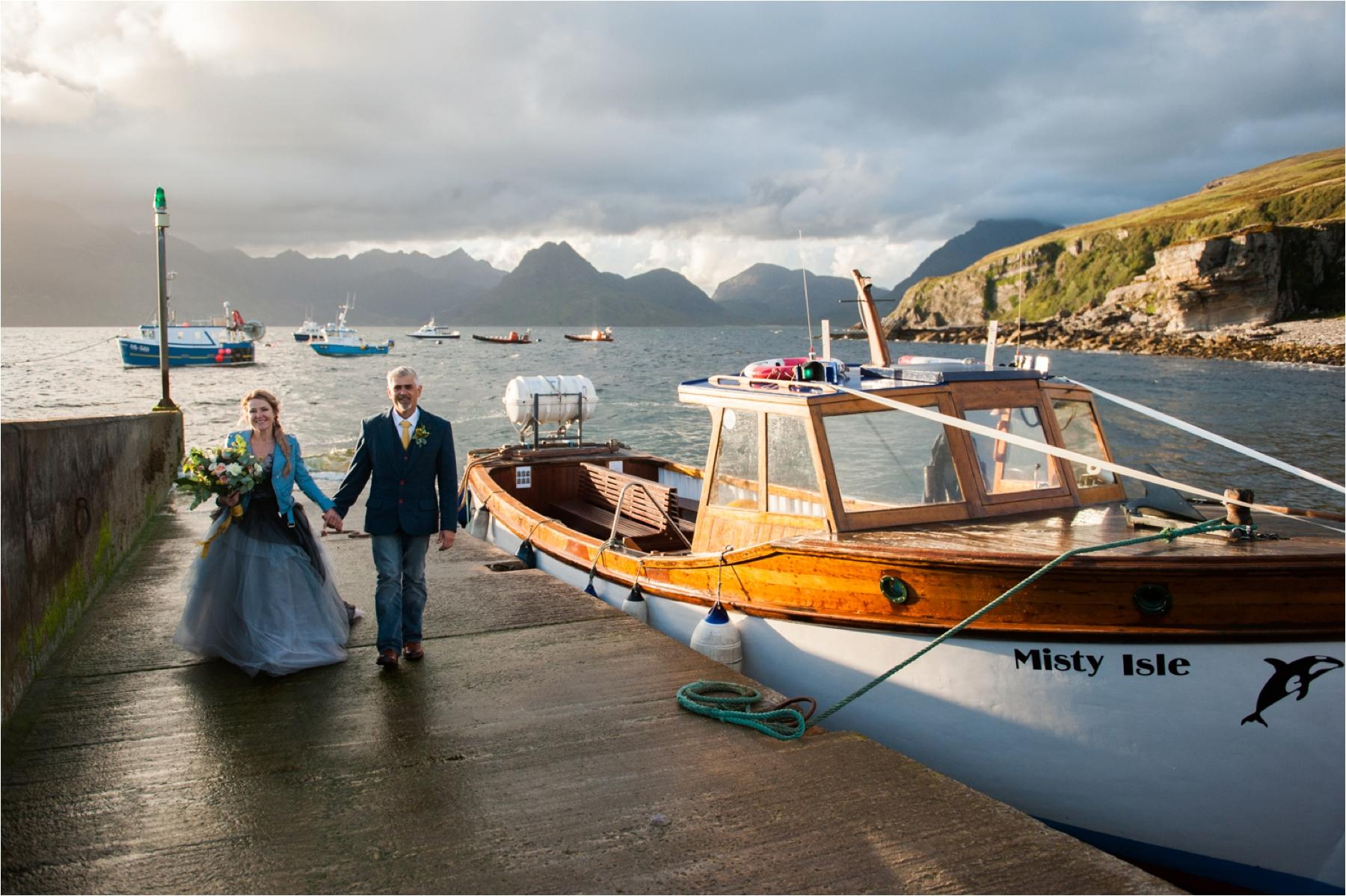 The bride and groom leave the Misty Isle boat after their civil marriage ceremony in dramatic weather. 