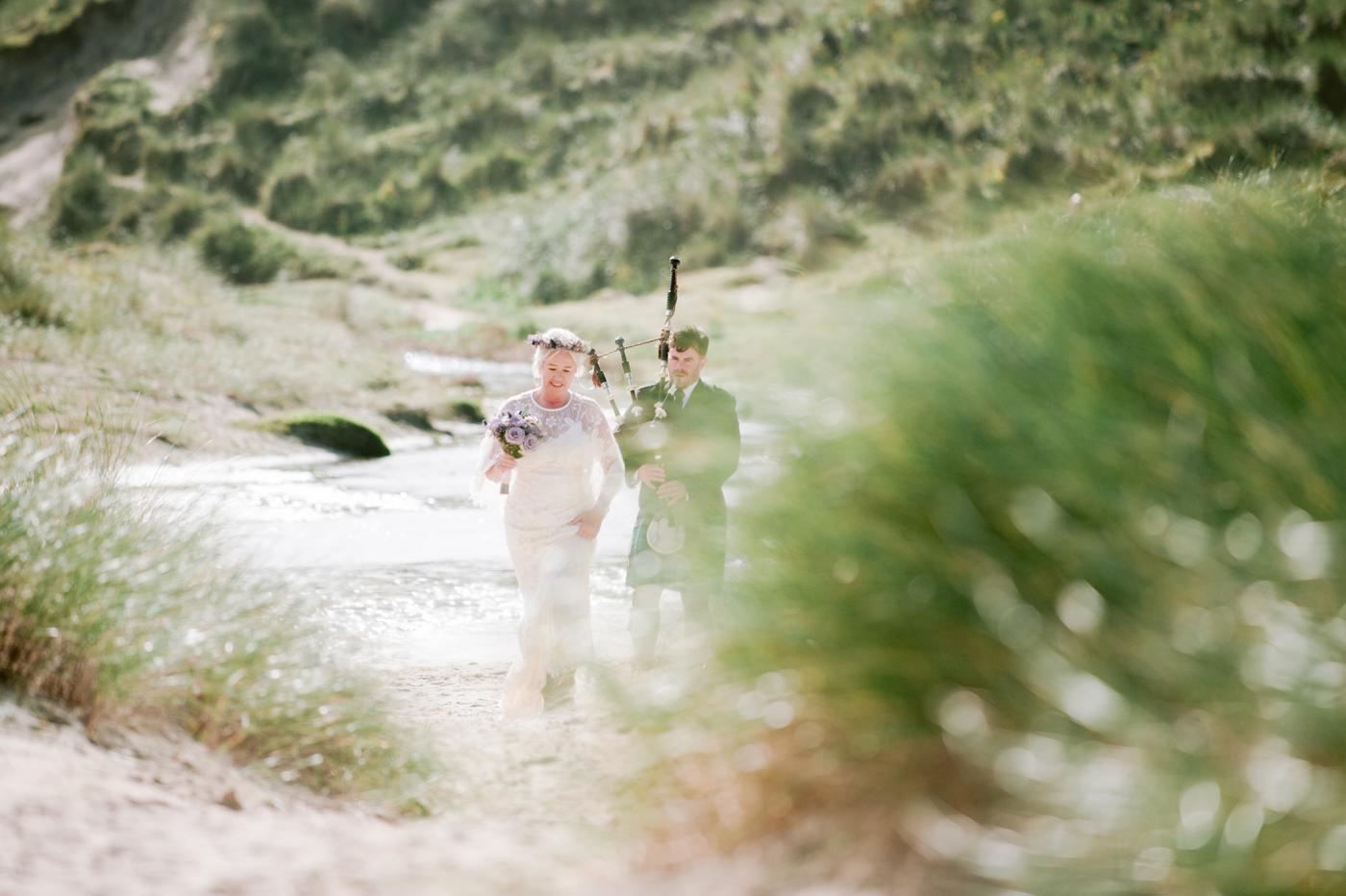 Piper playing in the dunes at Marge and David's Luskentyre wedding