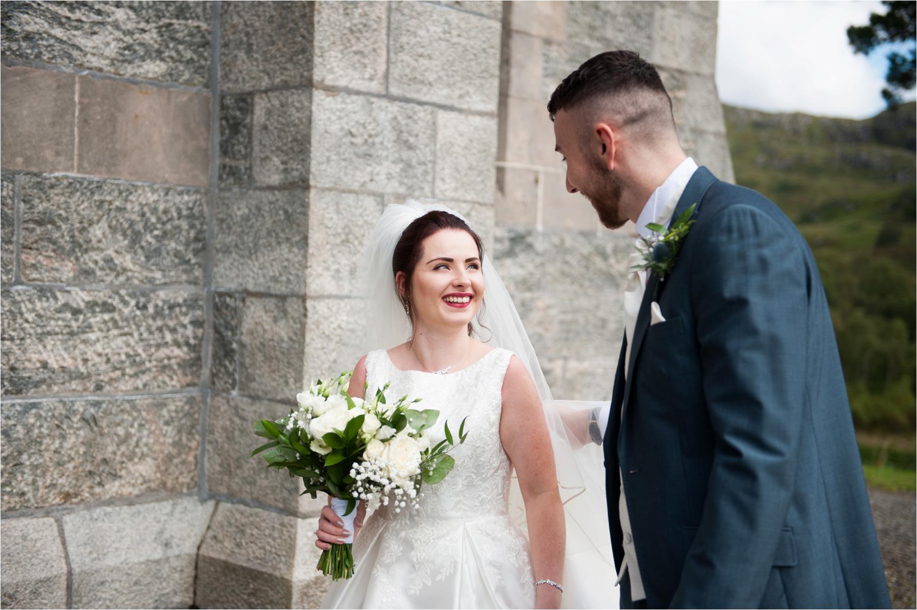 couple shot at glenfinnan church wedding Scotland