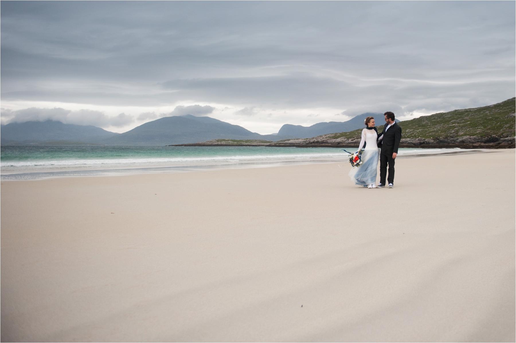 Outdoor wedding photography in the Outer Hebrides. This couple is alone on Scarista Beach under storm skies, following their elopement. 