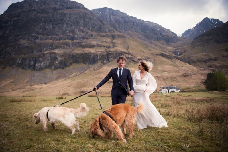 A brand groom and their dogs walk through the Scottish Highlands for wedding portraits after their elopement.
