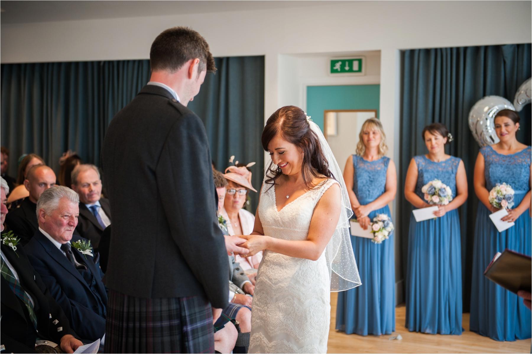 A bride and groom exchange rings during their humanist wedding ceremony on the Isle of Harris. Photographer: Margaret Soraya