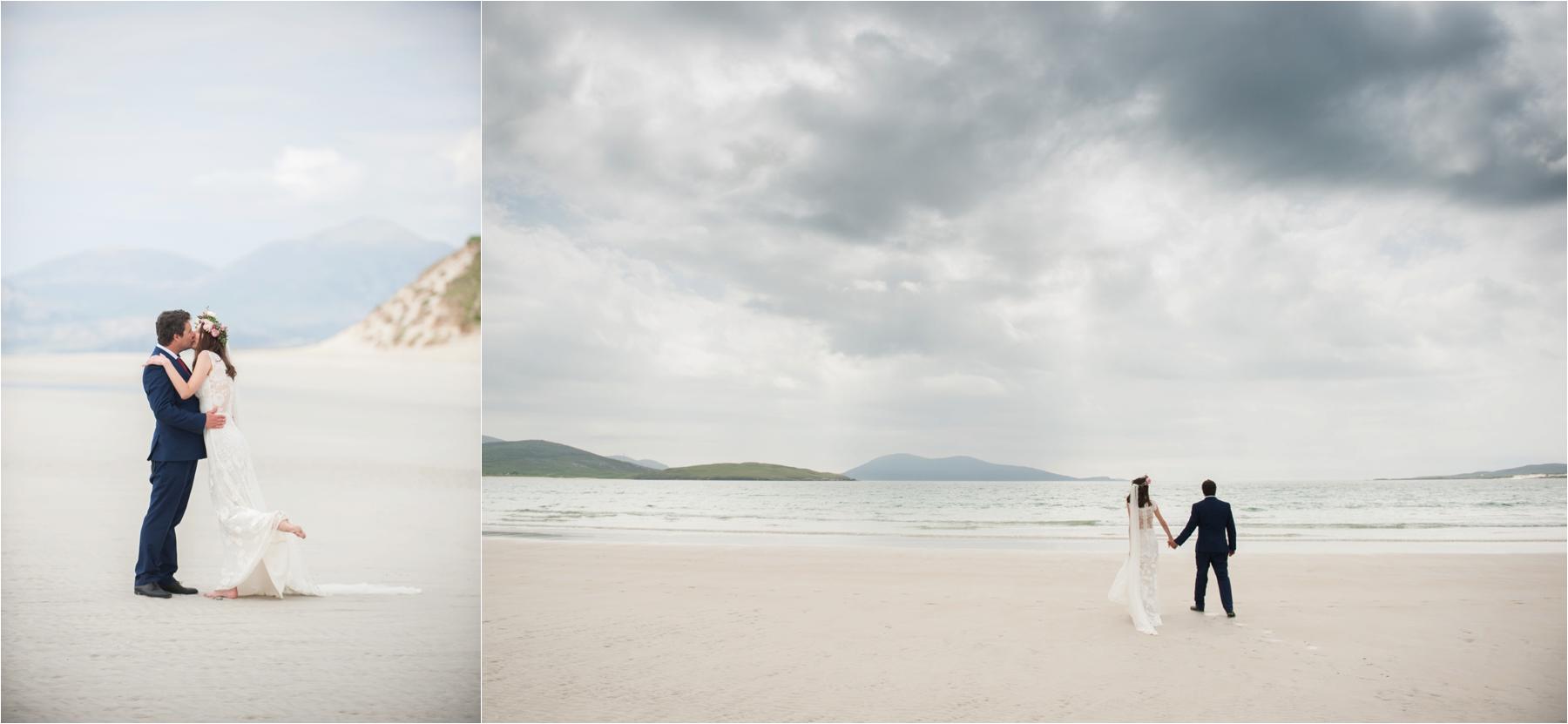 Bride Ilona is barefoot in her full-length white wedding gown as she and groom Emil walk along Luskentyre Beach after their elopement.