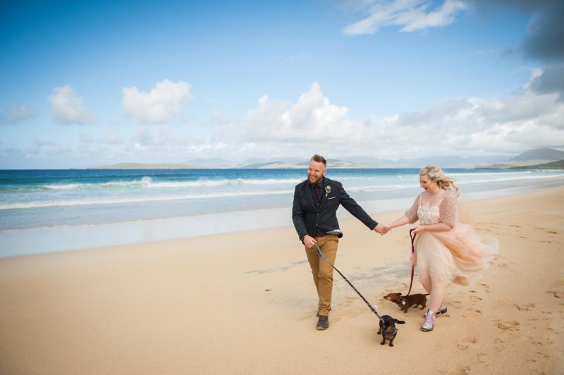 Isle of Harris beach wedding with a bride and groom and their two dogs.