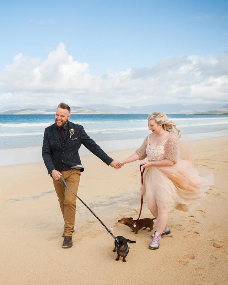 Isle of Harris beach wedding with a bride and groom and their two dogs.