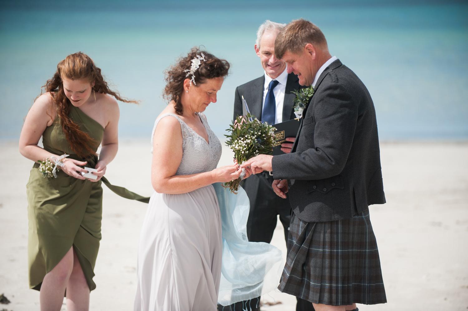 exchanging vows at Calgary bay beach wedding ceremony photograph