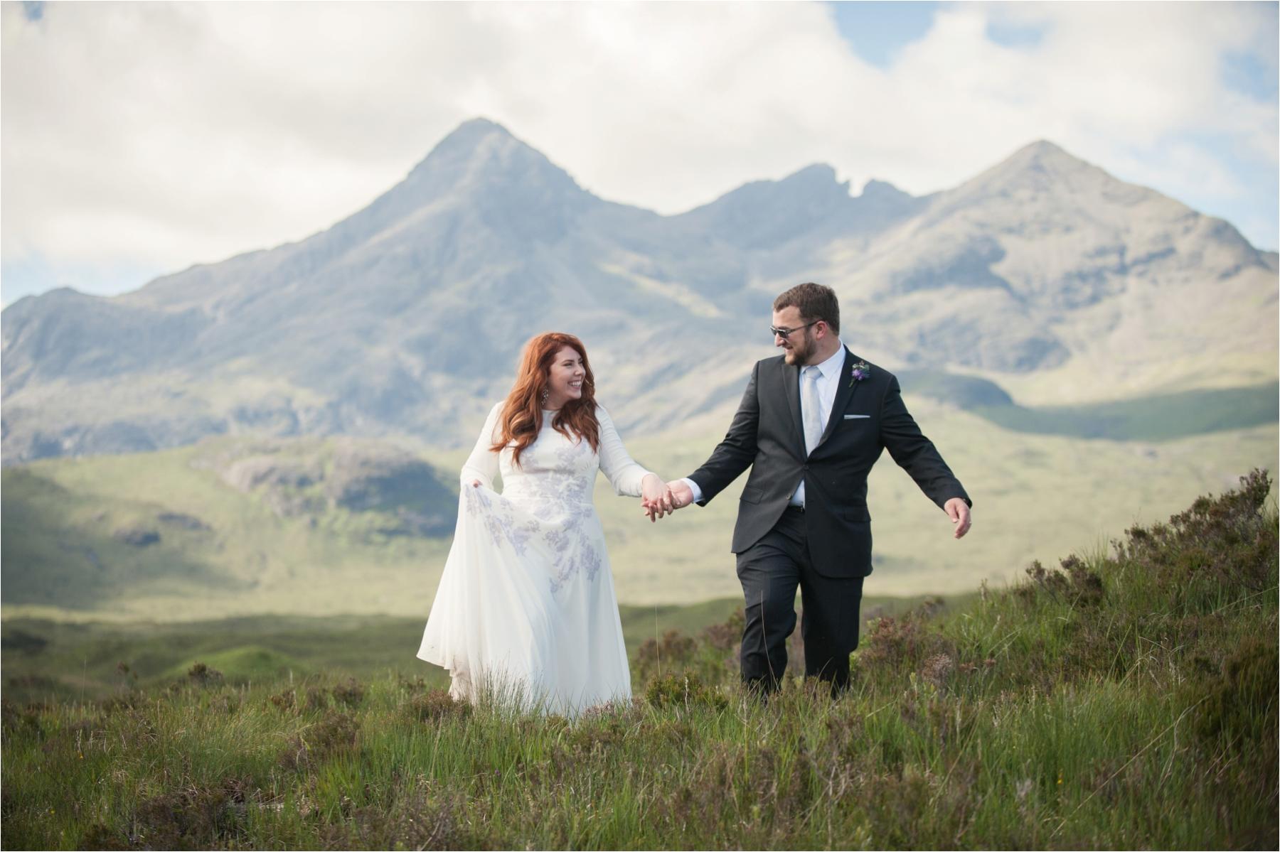 A couple walks through the scenic A couple from Texas has their wedding ceremony on the old bridge at Sligachan on the Isle of Skye.