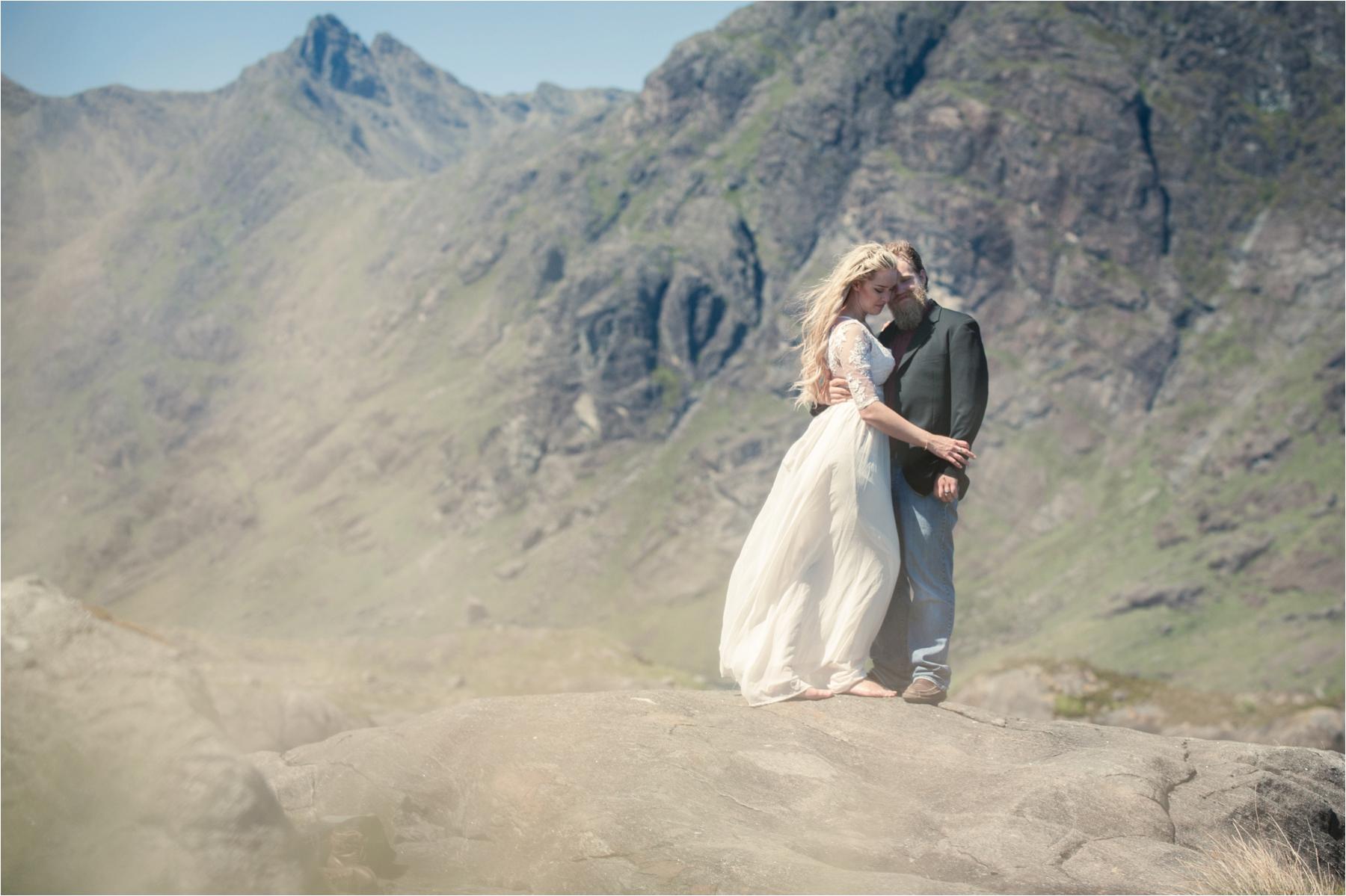 Romantic isle of Skye portrait photo of a couple with mountains behind. 