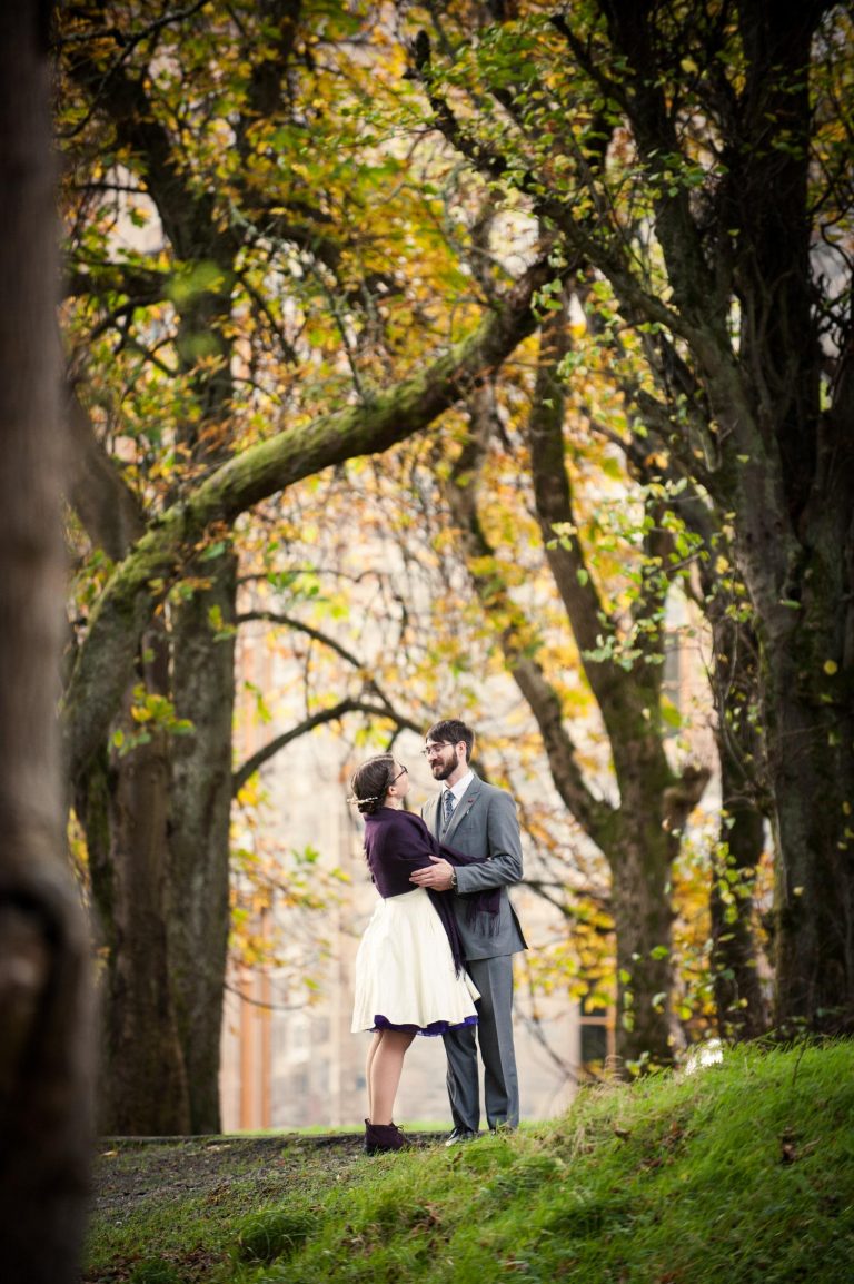 A bride and groom pose for a portrait outside Lews Castle on Stornoway on the Isle of Lewis.