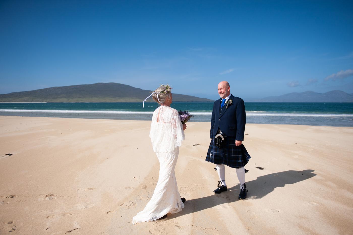 Bride and groom walking along Luskentyre Beach, Isle of Harris