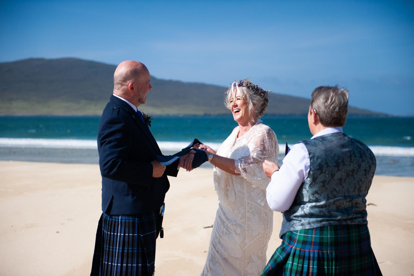 Wedding ceremony on Luskentyre Beach with piper and celebrant