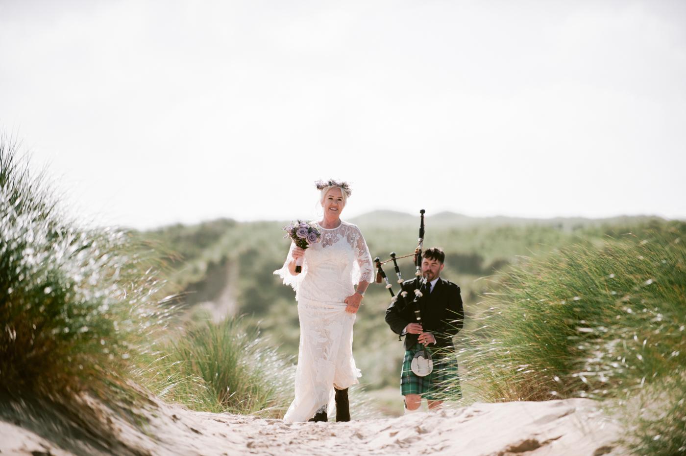 Piper playing in the dunes at Marge and David's Luskentyre wedding