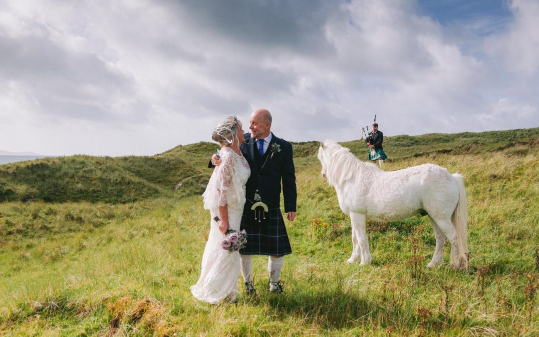 Bride and groom with Toby the white horse