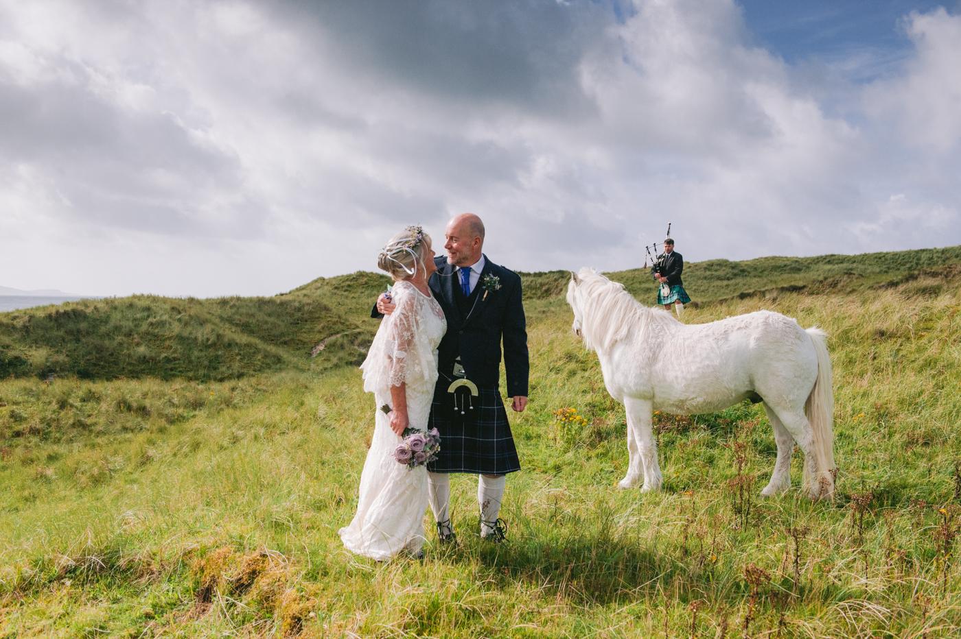 Bride and groom with Toby the white horse