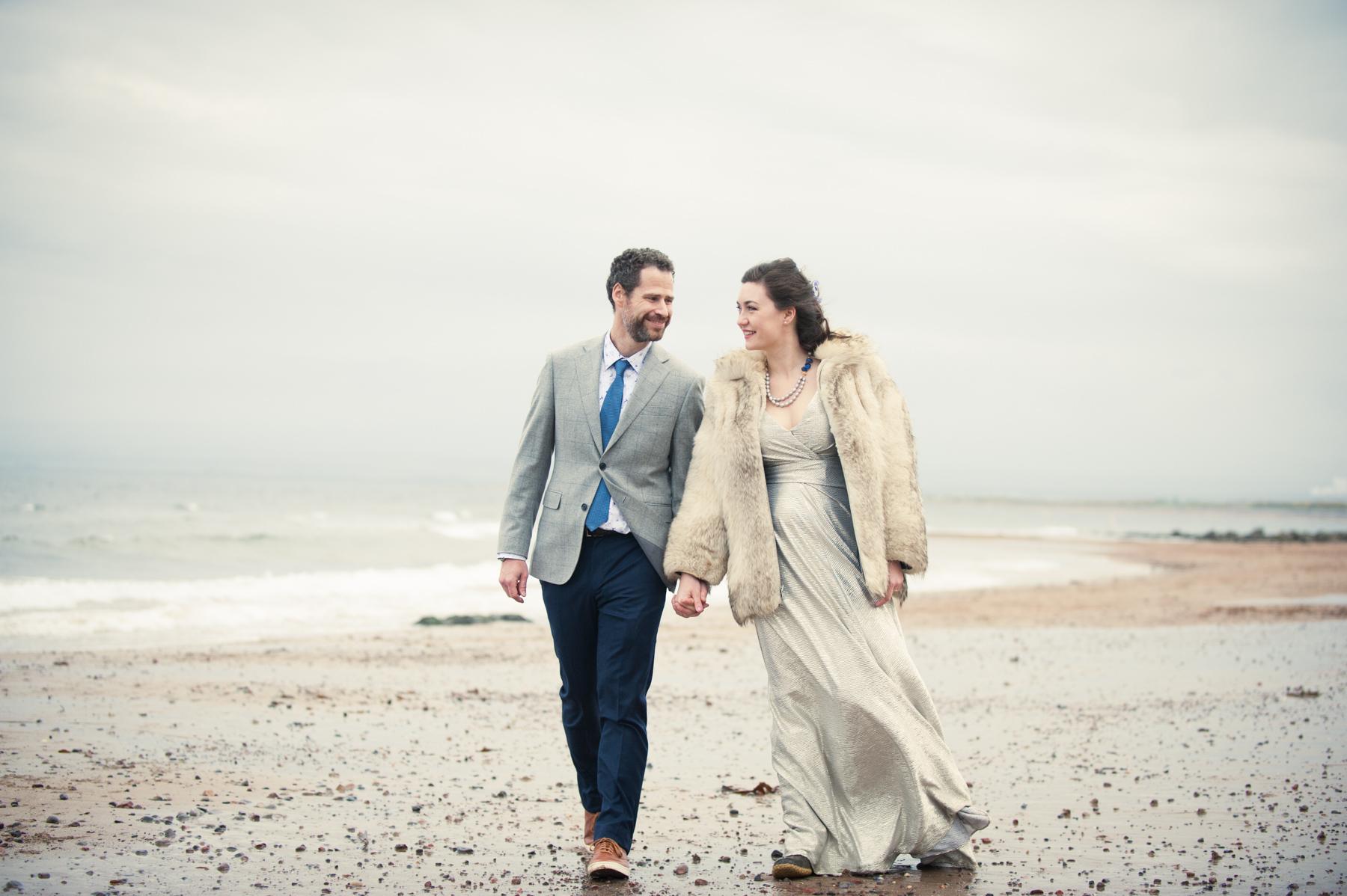 bride and groom beach walk after highland wedding photograph