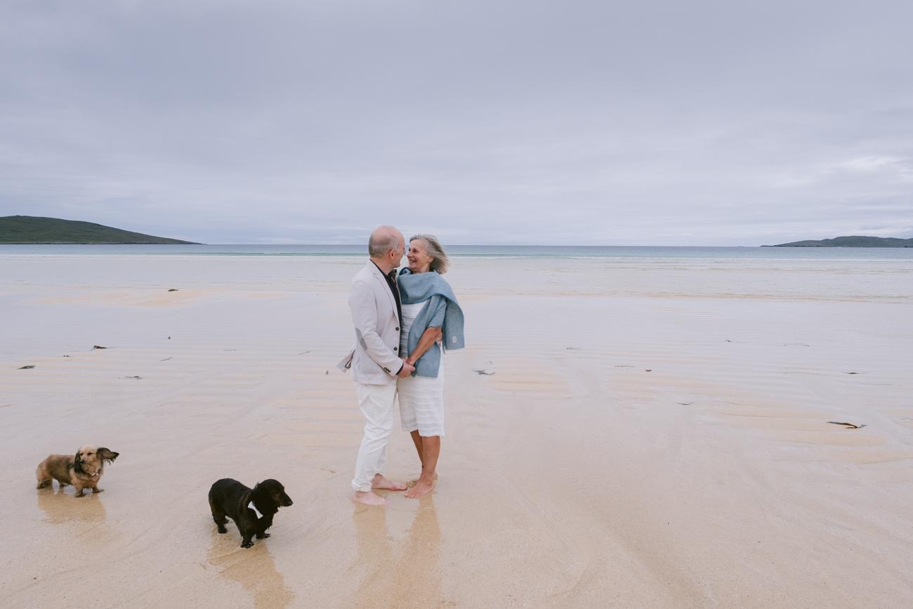Couple walking on the sand at Scarista beach wedding, Outer Hebrides 