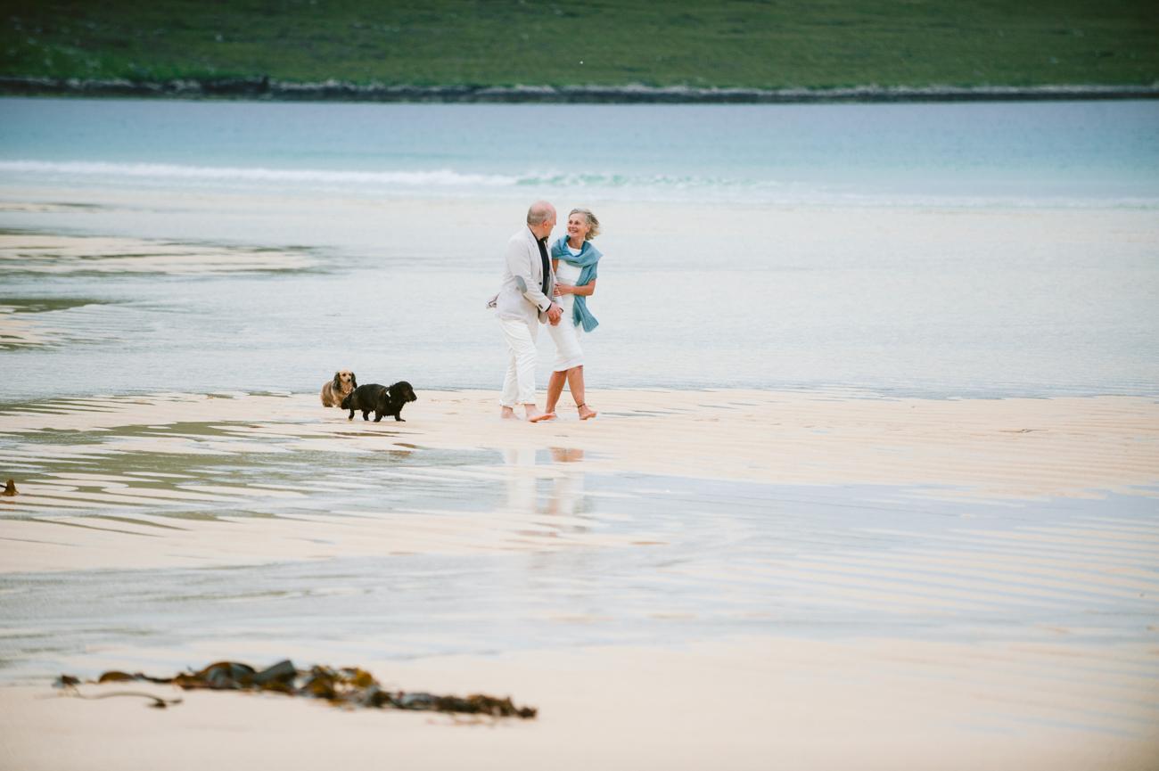 Couple walking on the sand at Scarista beach wedding, Harris