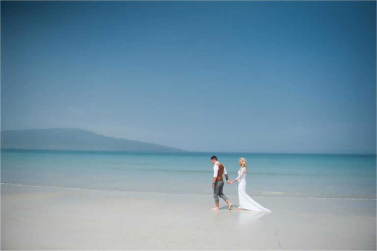 couple walking in the sea on the outer hebrides