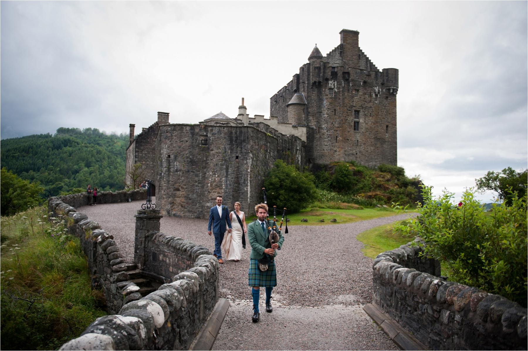 Piper at iconic Eilean Donan Castle, piping out the bride and groom after their courtyard wedding ceremony. 