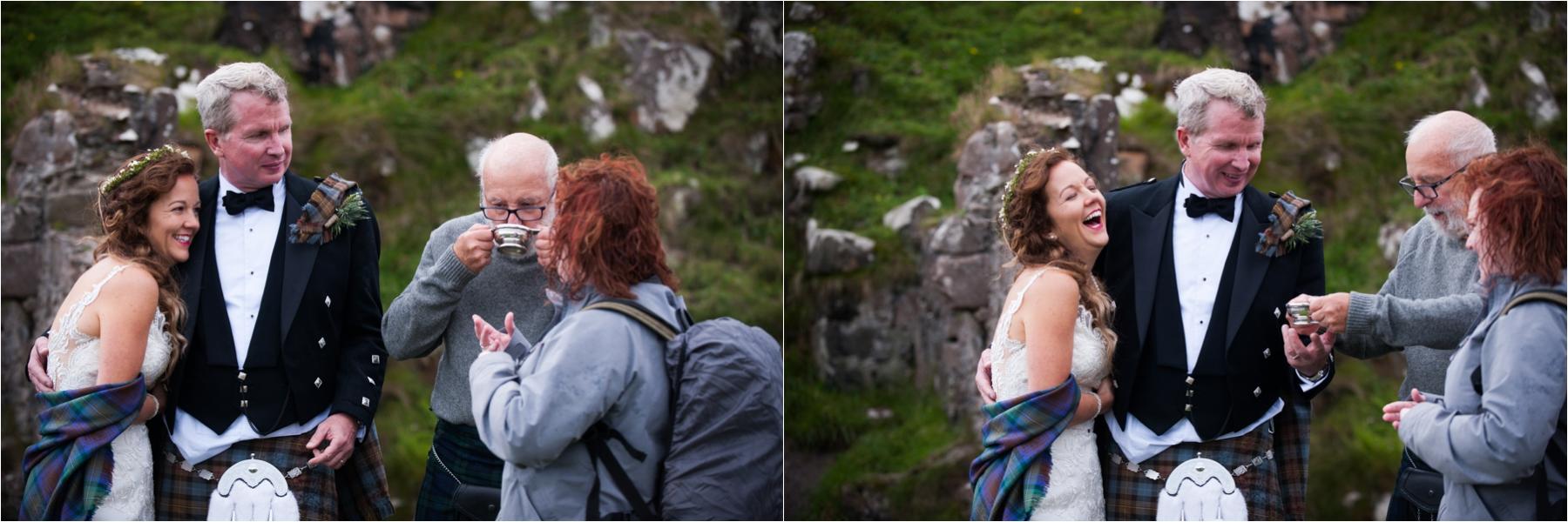 Newlyweds laugh after their humanist ceremony on the Isle of Skye in the ruins of Dunscaith Castle. 